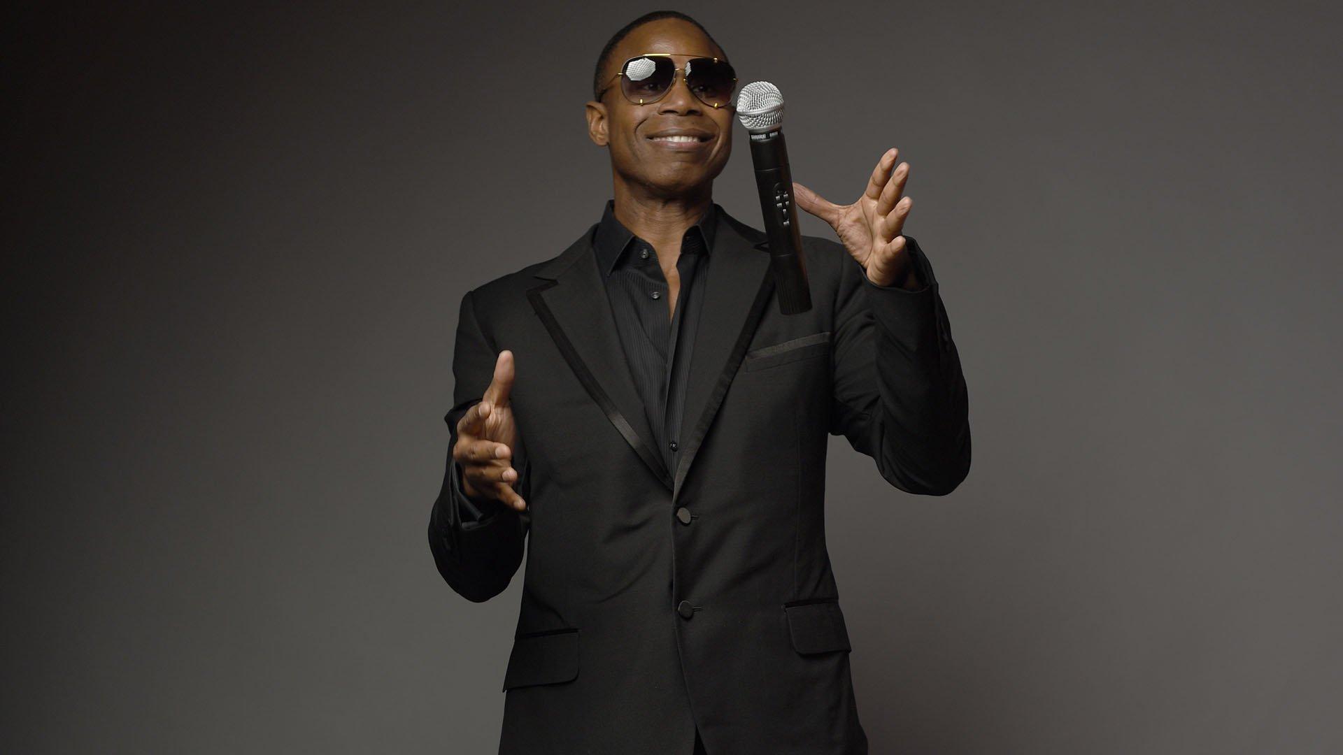 Doug E. Fresh smiles and catches a microphone